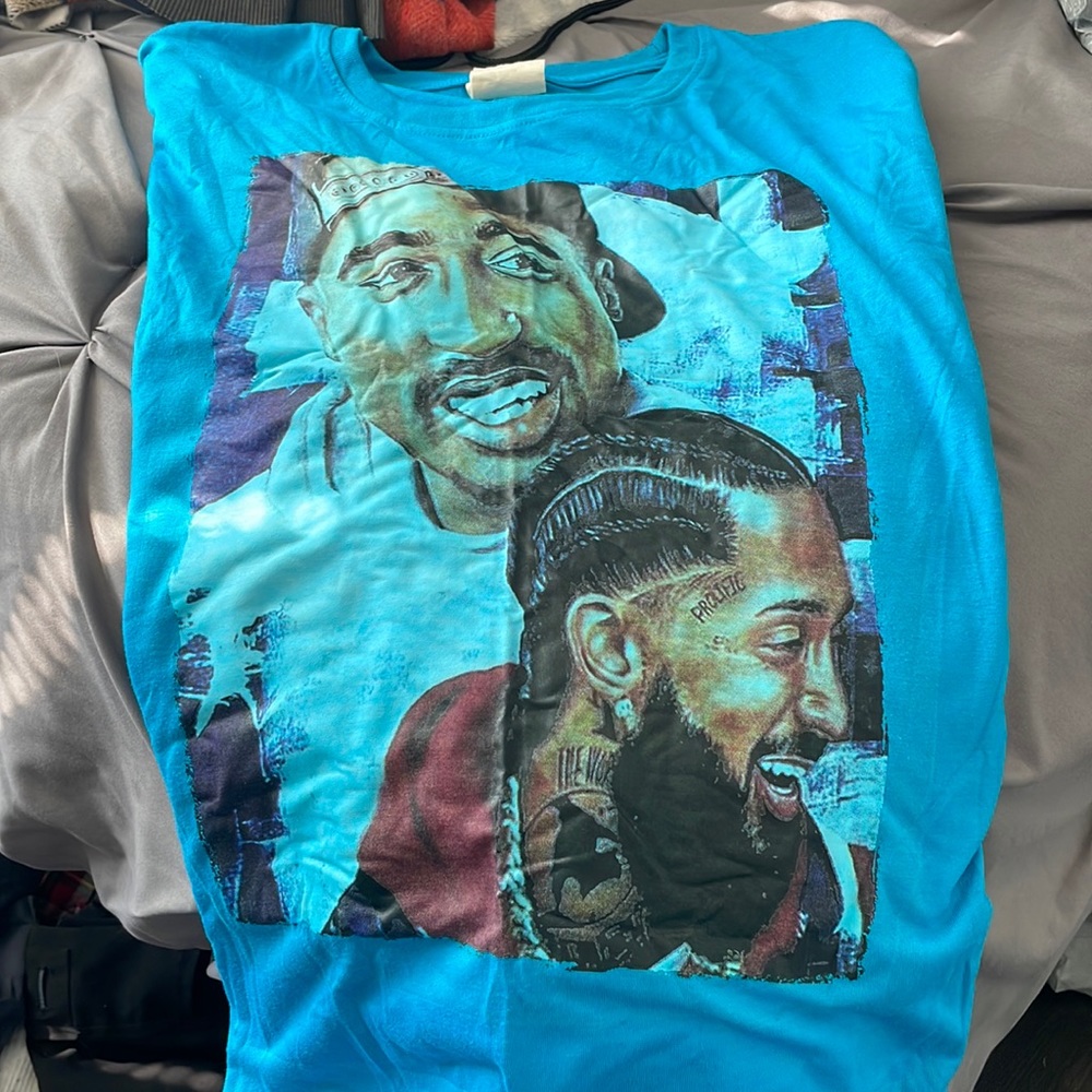 Blue long sleeve shirt that has 2Pac and Nipsey Hussle on it